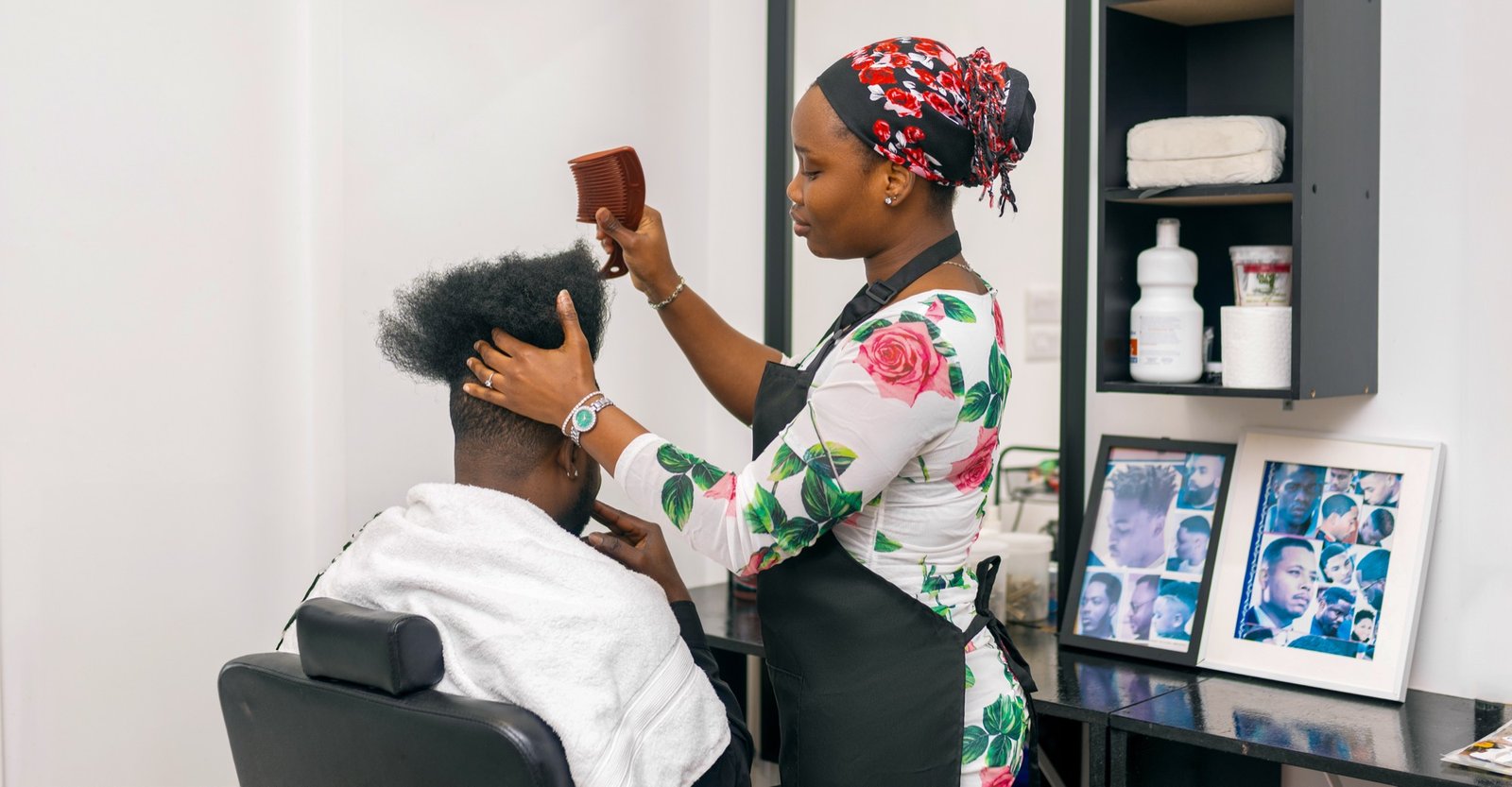 An Ade Blessing stylist attending to a client in the studio