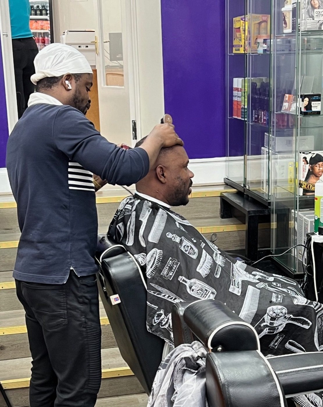 A master barber giving a fresh cut at Ade Blessing Salon