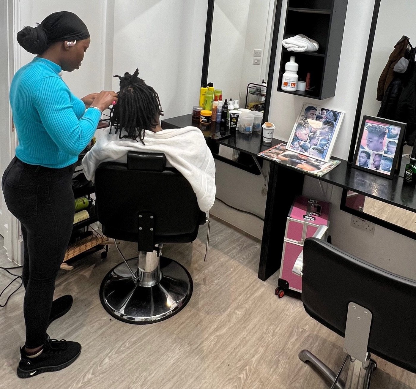 Stylist braiding a client's hair
